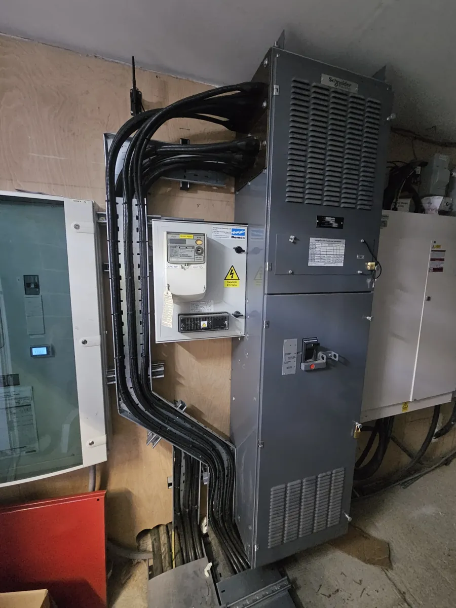 Schneider Electric floor-standing switchgear with heavy power cables and a metering enclosure, part of a new incoming supply for a commercial solar PV system in Lincolnshire, by PPM Electrical of Spalding