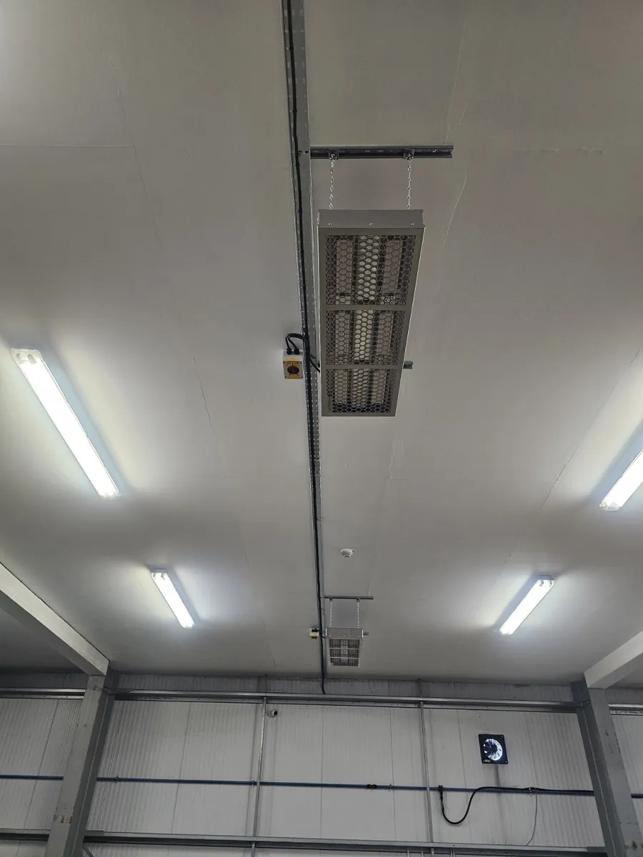 Electric radiant heaters with local isolators on the ceiling of a high commercial unit at Polyco in Bourne, Lincolnshire, installed by Spalding electricians PPM Electrical