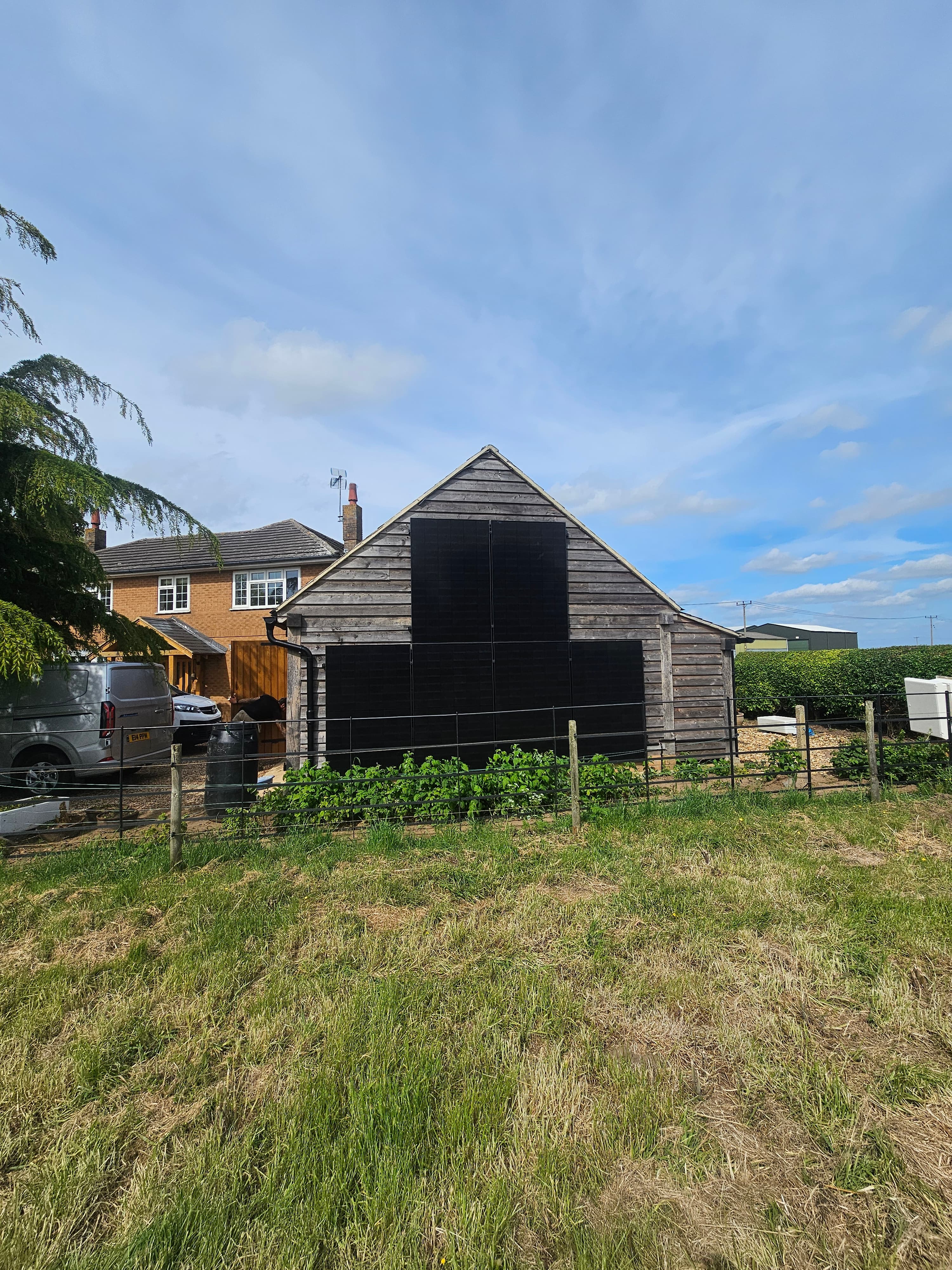 Solar panels mounted on a wooden outbuilding at a rural Lincolnshire property
